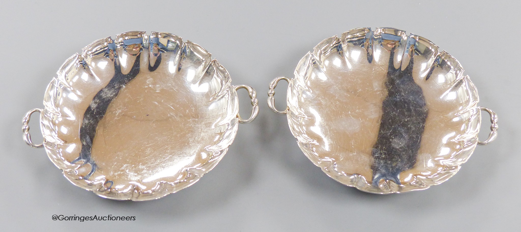 A pair of 1930's silver two handled shallow dishes, Goldsmiths & Silversmiths Co Ltd, London, 1937, 14.2cm, 8.5oz.
